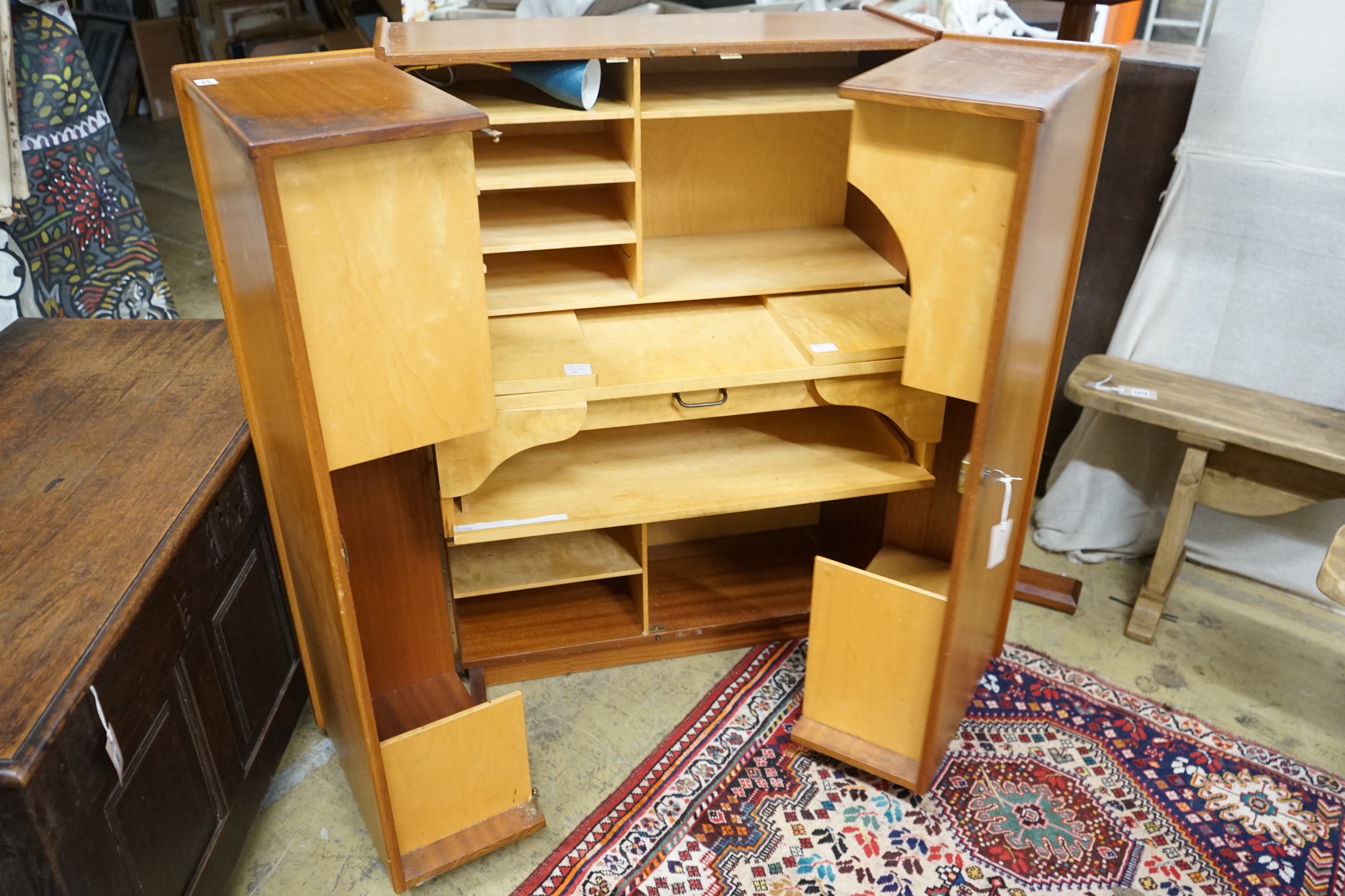 A mid century teak 'Magic Box' enclosed desk, width 82cm, depth 54cm, height 115cm